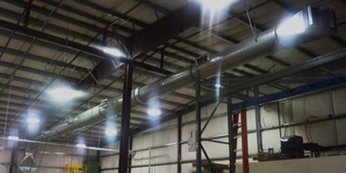 Custom industrial warehouse cooling system with exposed ductwork.